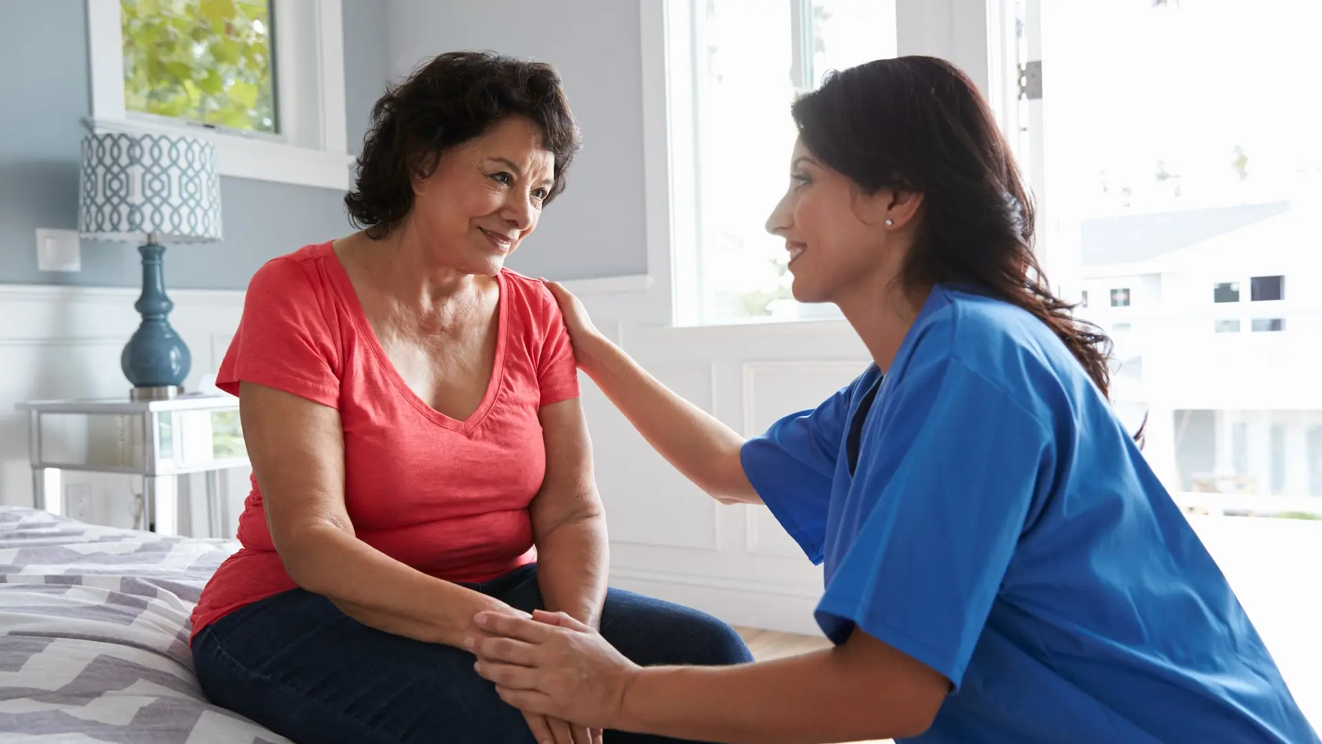 Care assistant helping care home resident