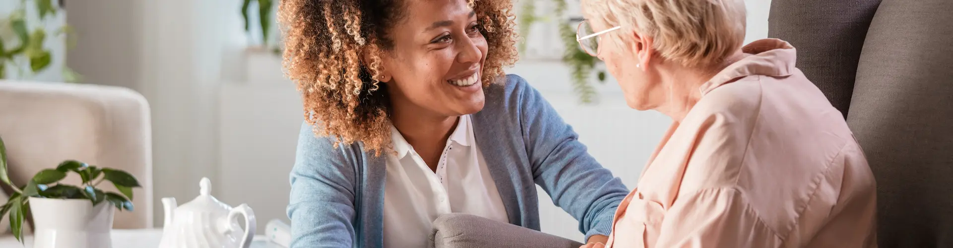 Support worker talking to someone and drinking tea