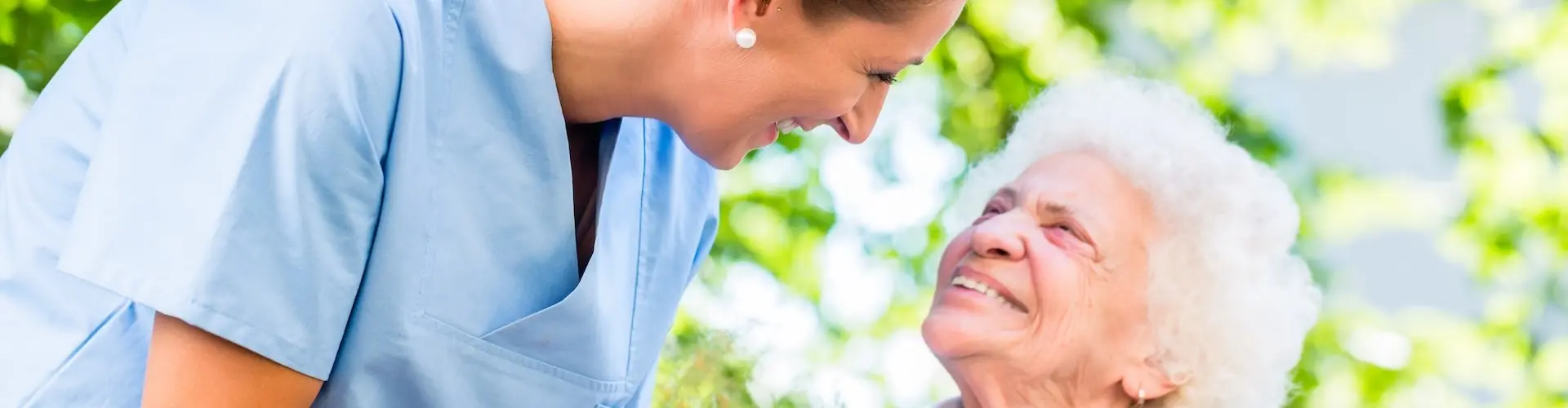 Care Assistant talking to elderly patient
