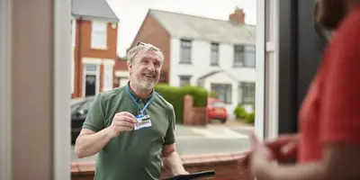 Social Worker showing his identity at a front door