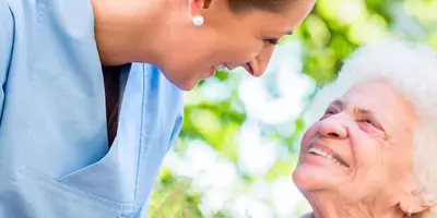 Care Assistant talking to elderly patient