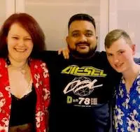 Photo of Reetesh with two people he supports